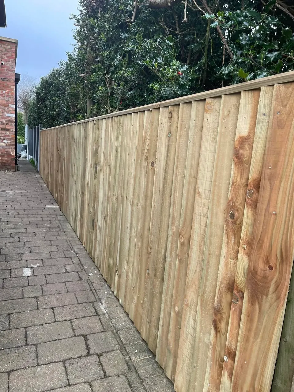 Close-board fencing along side path