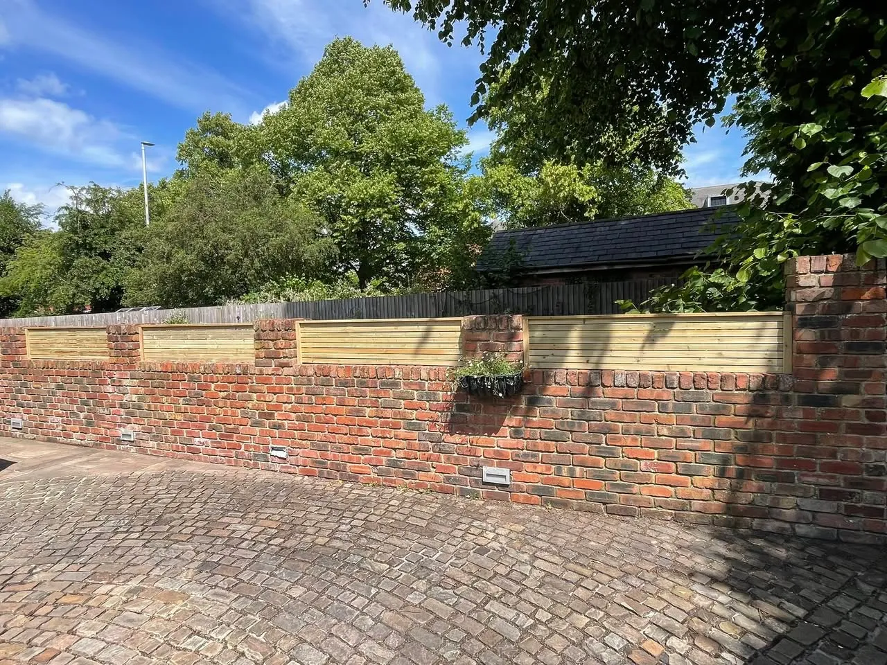 Horizontal timber panels integrated into brick wall